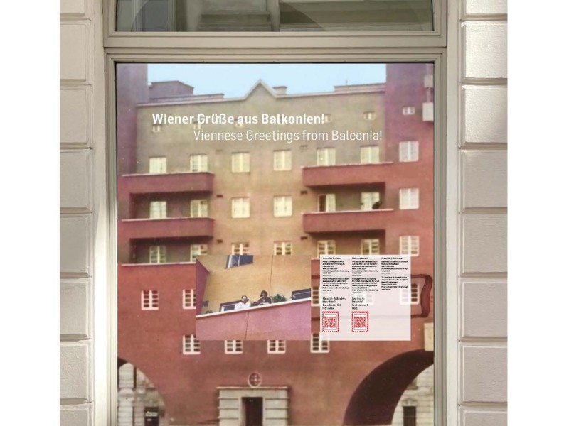 Window display at the Jewish Museum Vienna titled 'Wiener Grüße aus Balkonien!' with English subtitle 'Viennese Greetings from Balconia!' showing a photo of a residential building with balconies and a text panel with QR codes.