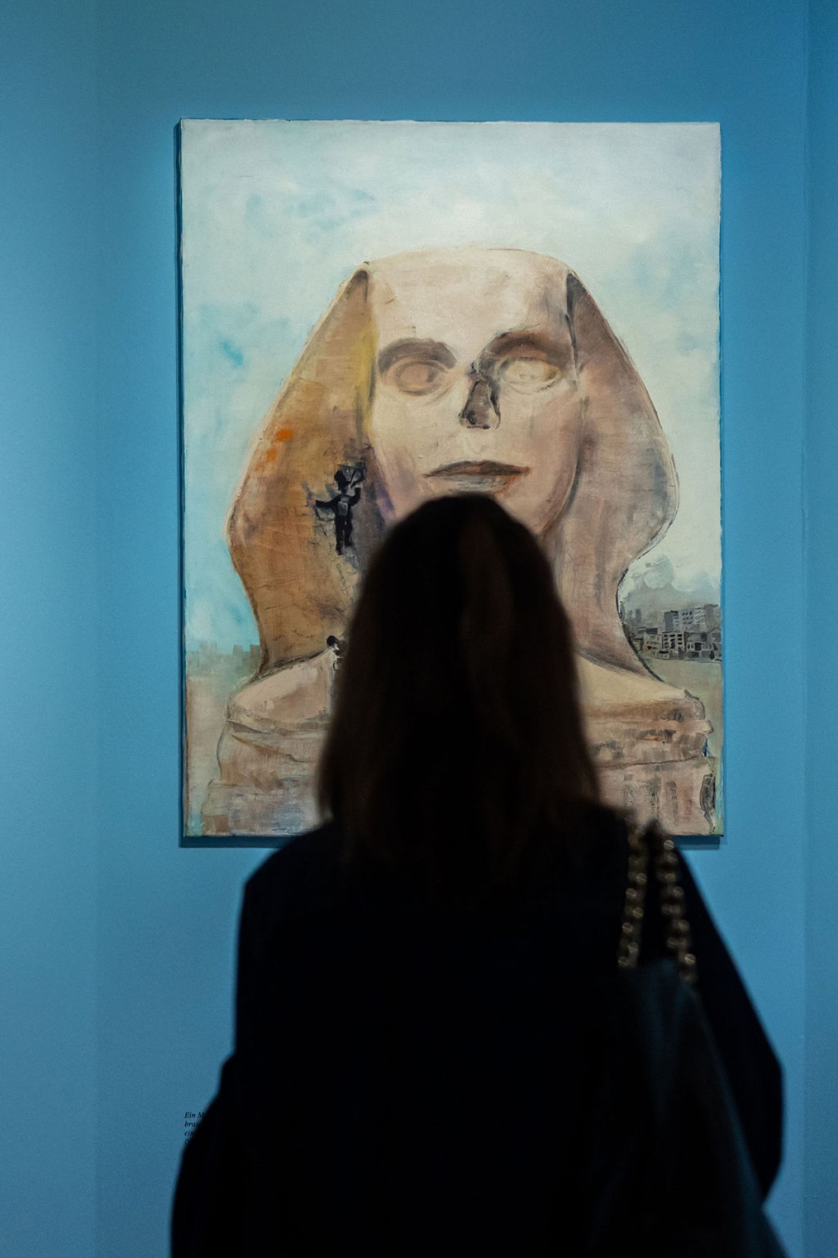 : A painting with a person in front of it
